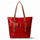 Red leather tote bag with brown straps and accents on a white background