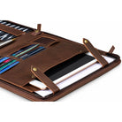 Open black leather zippered portfolio with a notepad held by elastic straps on the right, and card slots with hook