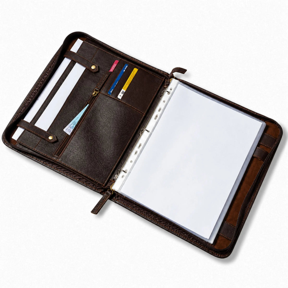 Open leather-bound planner with pen holder and blank pages on a white background