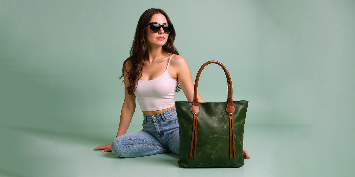 Woman holding a green handbag against a light green background
