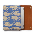 Tablet laptop sleeve with blue background and beige tiger pattern, next to a brown leather case.