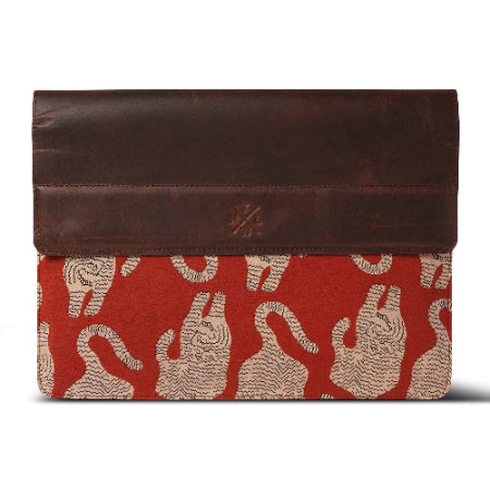 Brown leather laptop sleeve with red and beige pattern on a white background