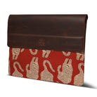 Brown leather laptop sleeve with red fabric featuring tiger pattern on a white background
