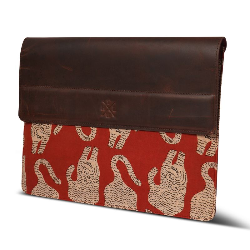 Brown leather laptop sleeve with red fabric featuring tiger pattern on a white background