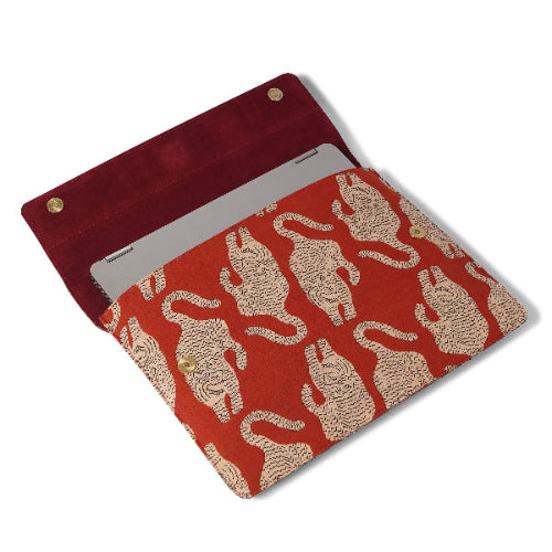 Red laptop sleeve with beige tiger pattern on a white background