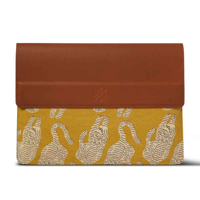 Brown leather and yellow fabric laptop sleeve with a pattern on a white background