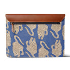 Blue laptop sleeve with tiger  pattern and brown leather flap on a white background