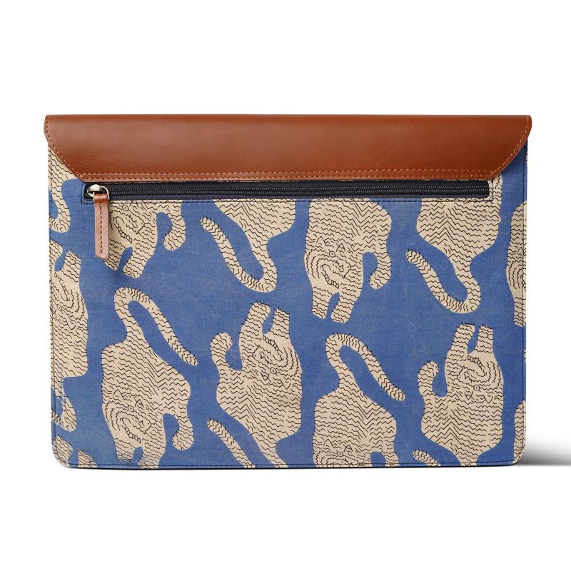 Blue laptop sleeve with tiger  pattern and brown leather flap on a white background