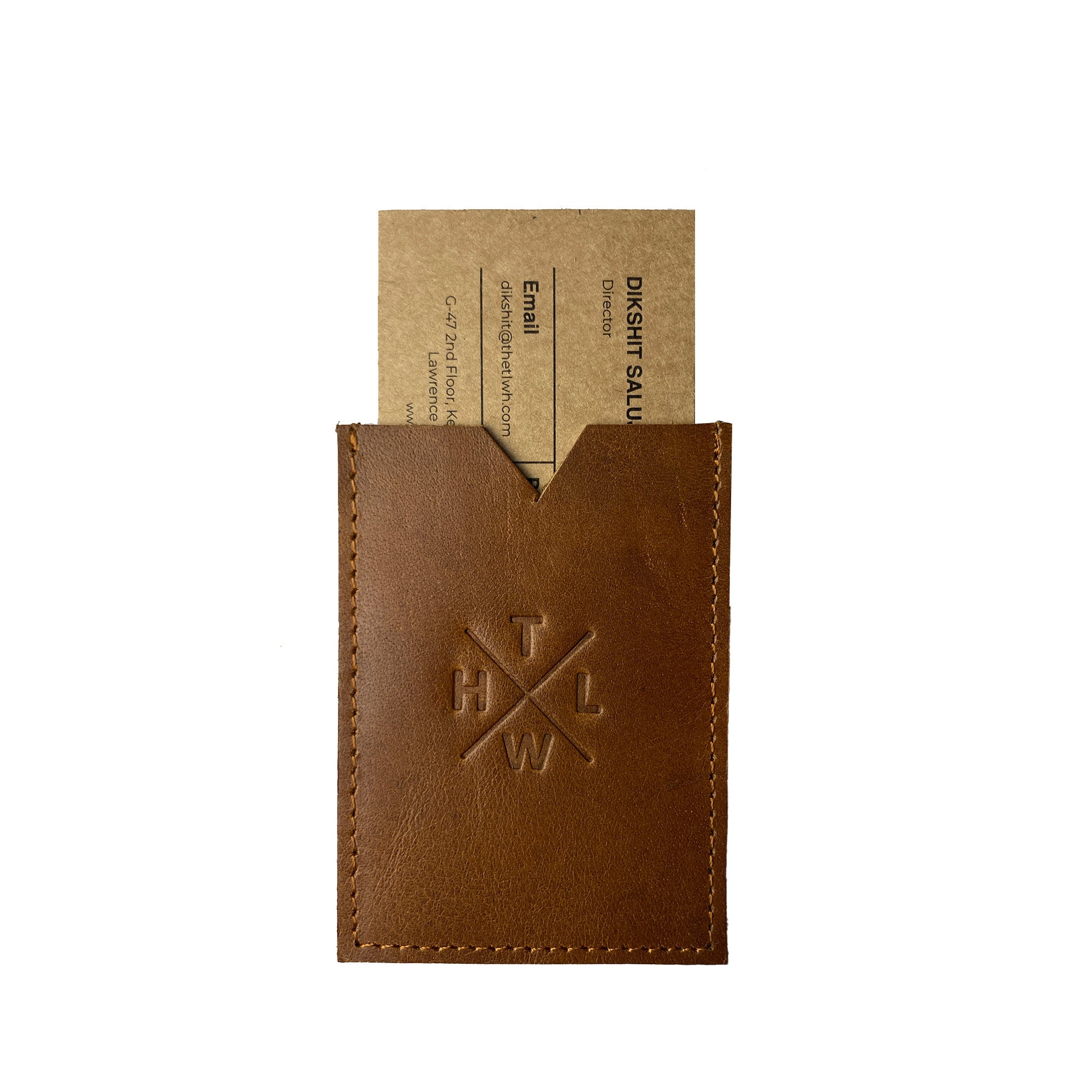 Brown leather cardholder with a business card inside on a white background