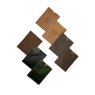 Set of five leather coasters in different colors on a white background