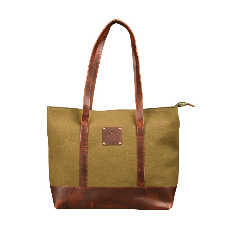 Green tote bag with brown leather handles and trim on a white background