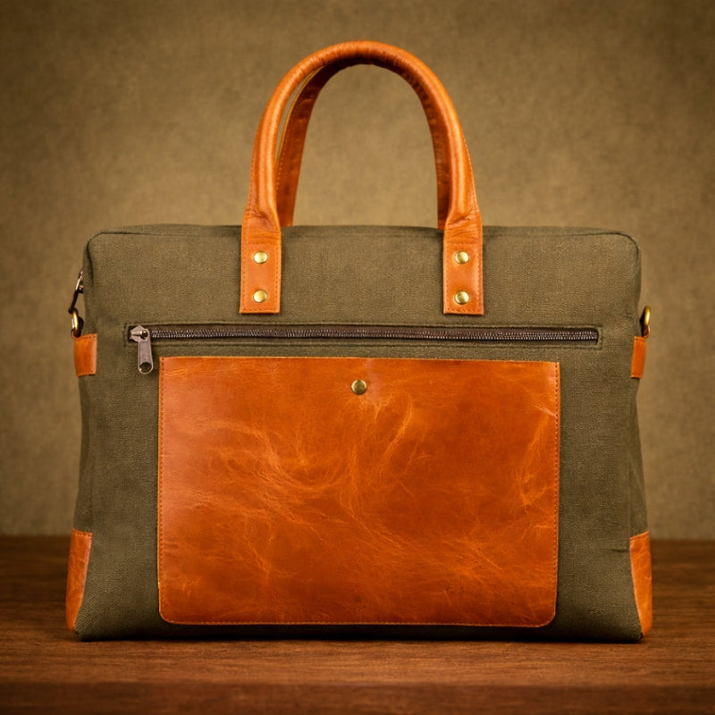 Green and brown canvas & leather bag on a wooden surface with a brown background