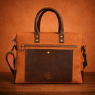 orange canvas &  leather handbag with a visible brand logo on a brown background
