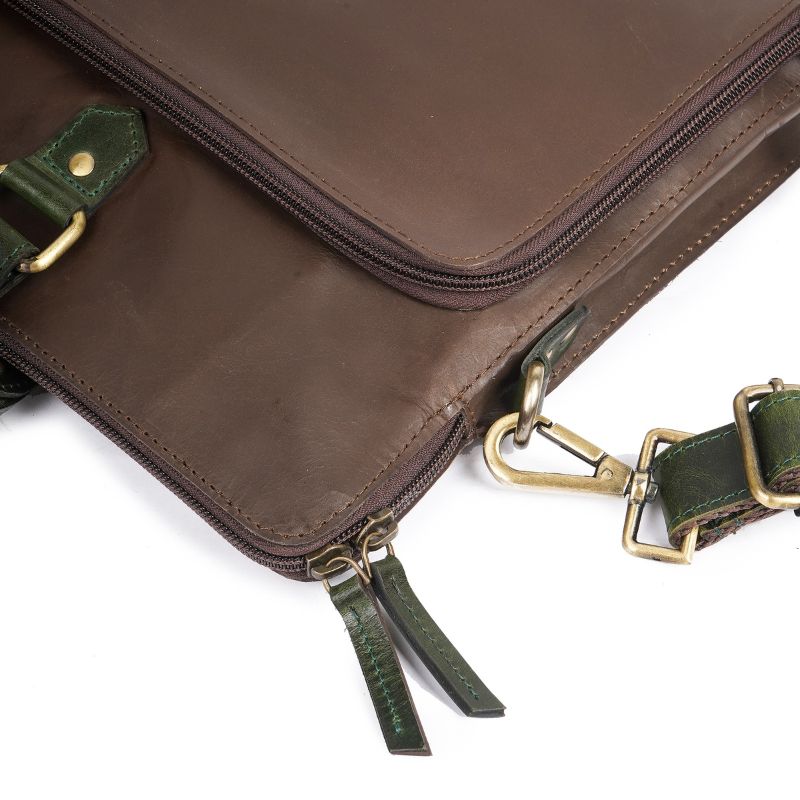 Chocolate Brown leather bag with green straps and gold hardware on a white background