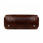 Brown leather bag with silver studs on a white background