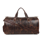 Brown leather duffel bag with straps on a white background