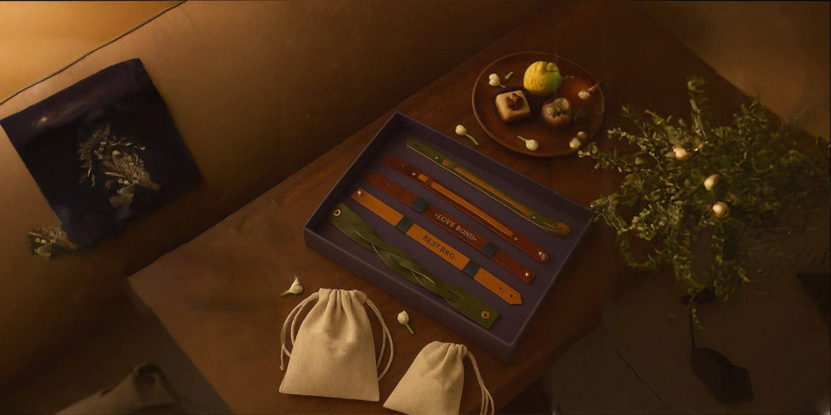Table setting with a box of tea, teabags, and a small plate of food in a warm, dimly lit room.