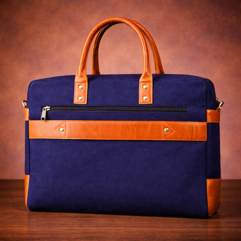 Blue canvas  bag with brown leather straps on a wooden surface and brown background