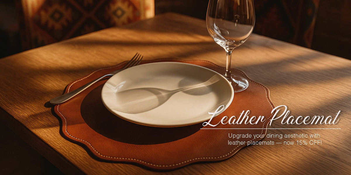 Dining table setting with a leather placemat, plate, fork, and wine glass.