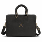 Black leather laptop bag with gold hardware on a white background