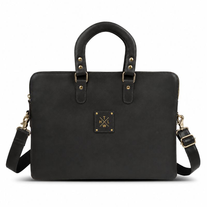 Black leather laptop bag with gold hardware on a white background