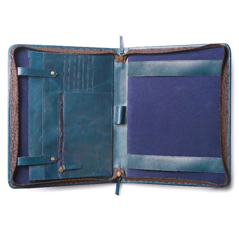 Open leather portfolio or padfolio in blue color, showing multiple pockets and slots on the left side for cards, pens, and documents, and a larger slot on the right for a notepad or papers.