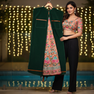 Woman holding a green embroidered dupatta with a blurred light background