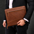 Man in a suit carrying the Executive A4 Leather Folder