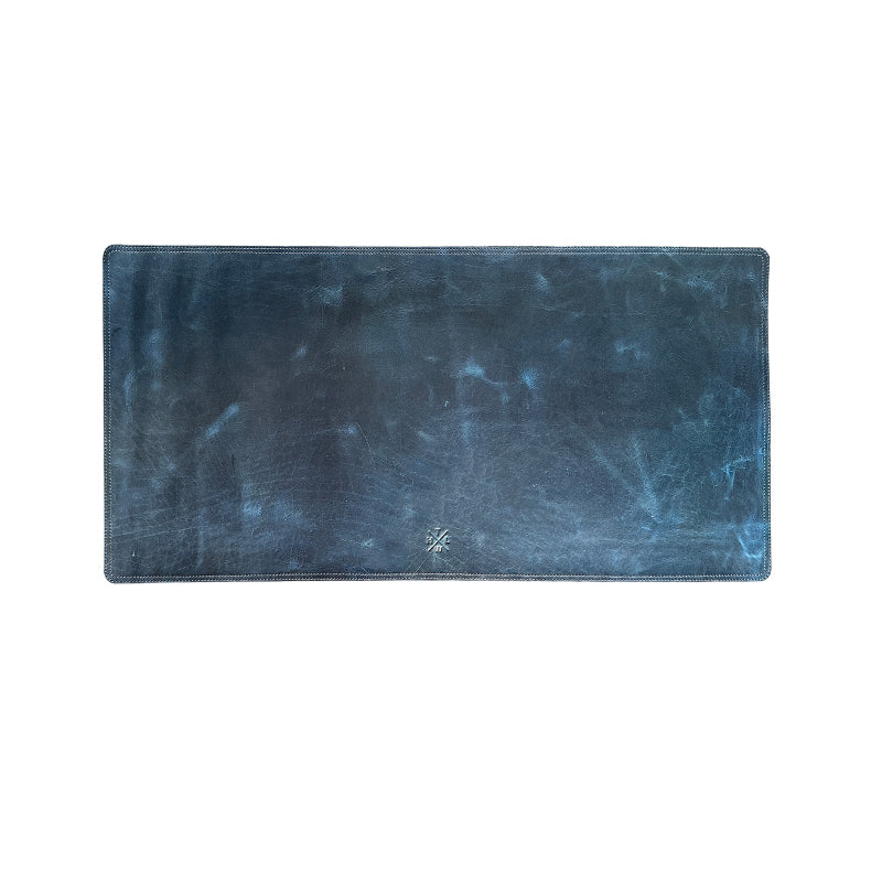 Rectangular blue rug with a textured surface on a white background