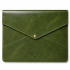 An olive green leather envelope-style pouch with a gold snap button closure and an embossed cross logo on the front, shown against a plain white background.