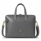 Gray leather laptop bag  with gold accents on a white background