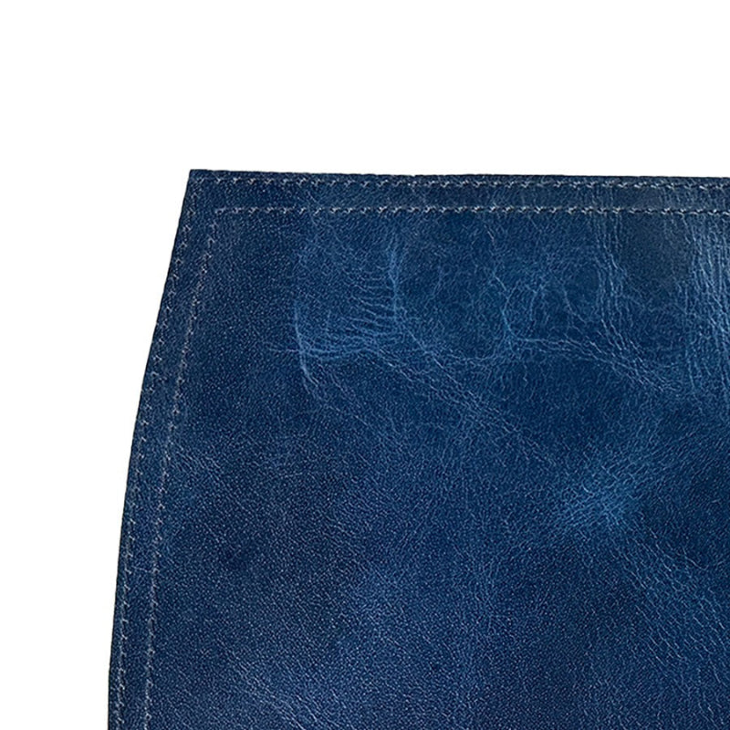 Close-up of a blue leather product with stitching detail on a white background