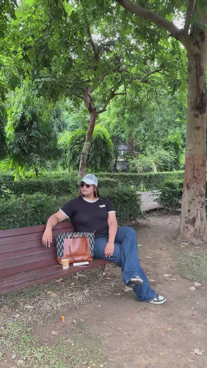 women showcase and use leather tote bag  in the park 