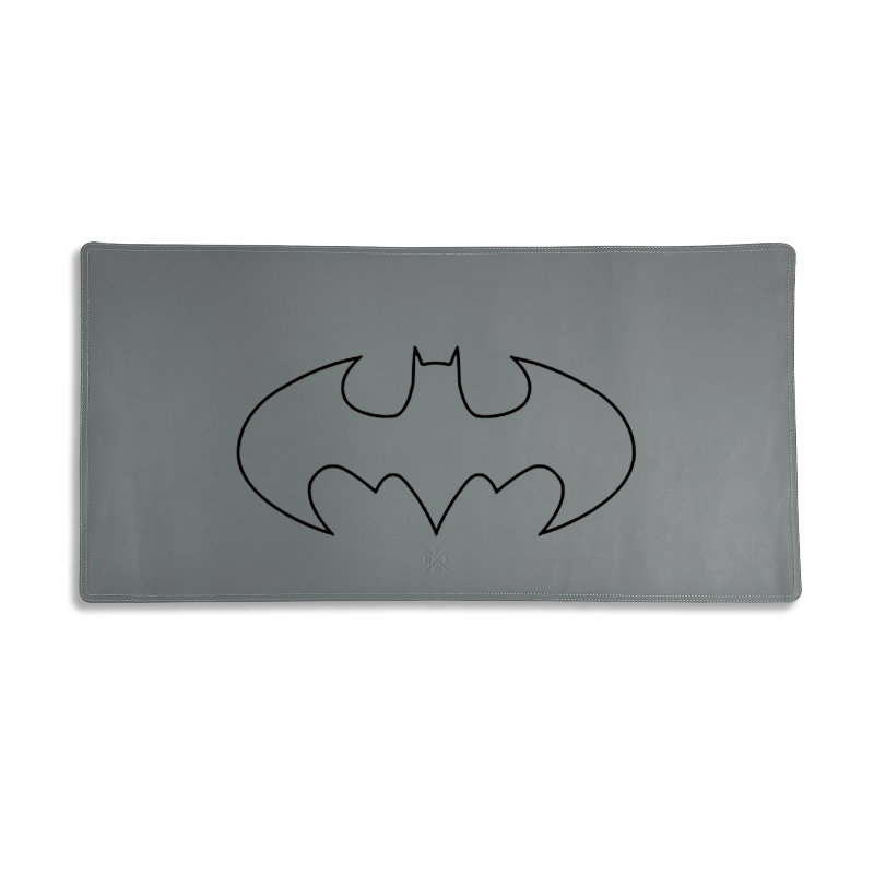 Gray desk/mouse pad with a black Batman logo on a white background